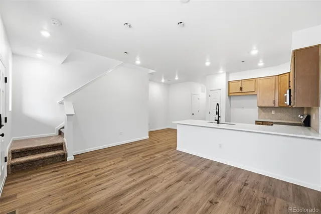 a kitchen with kitchen island a sink stainless steel appliances and cabinets