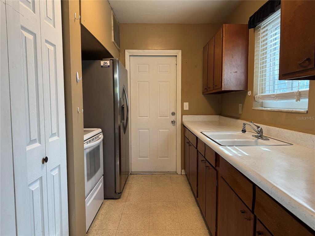 6315 Treehaven Drive Spring Hill, FL 34606 - Photo 12 of 21 a kitchen with a sink and a refrigerator