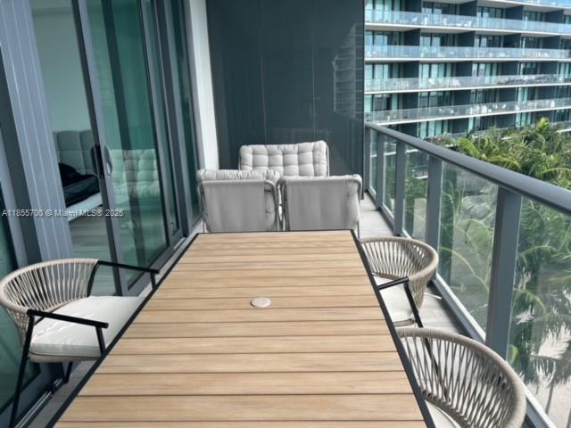 480 Northeast 31st Street, Unit 905 Miami, FL 33137 - Photo 6 of 15 a view of balcony with wooden floor and outdoor seating