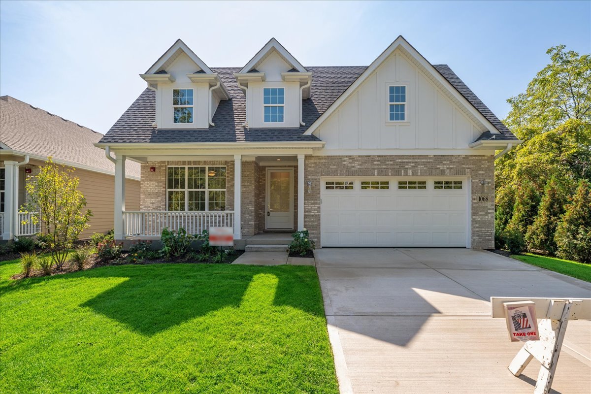 a front view of a house with a garden and plants