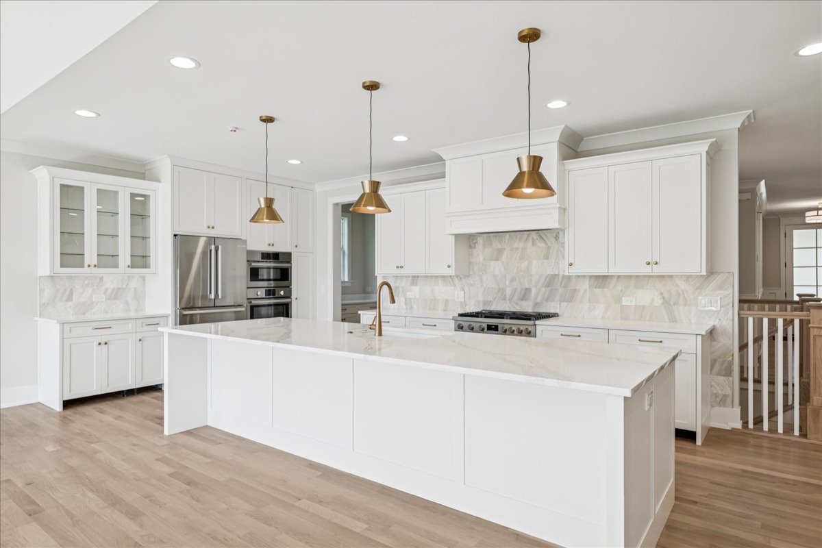 1068 Livingston (lot 1) Avenue Highland Park, IL 60035 - Photo 6 of 33 a kitchen with stainless steel appliances granite countertop a sink a stove a refrigerator and white cabinets with wooden floor