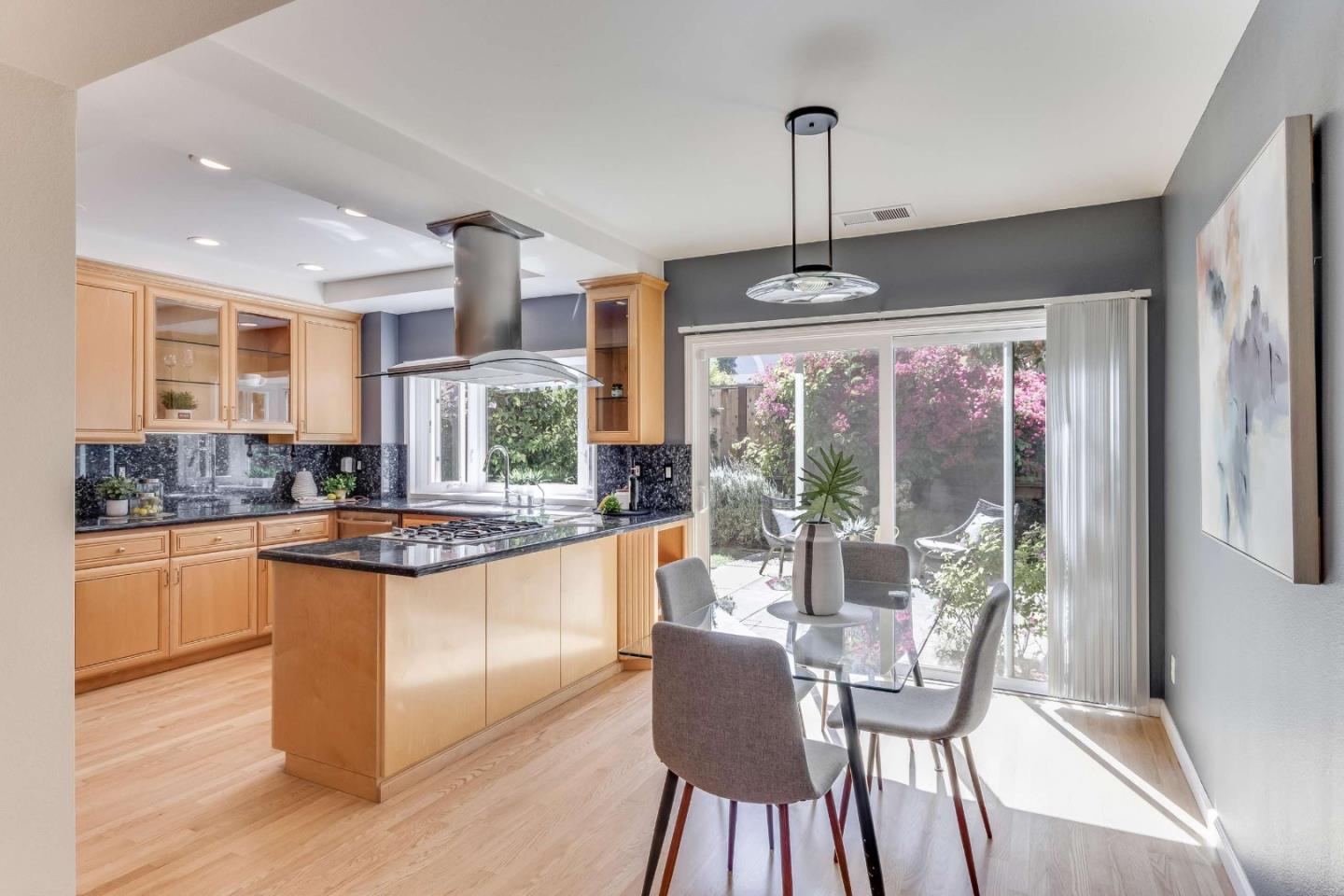 11627 Cedar Spring Court Cupertino, CA 95014 - Photo 12 of 54 a kitchen with stainless steel appliances granite countertop a stove and white cabinets with wooden floors