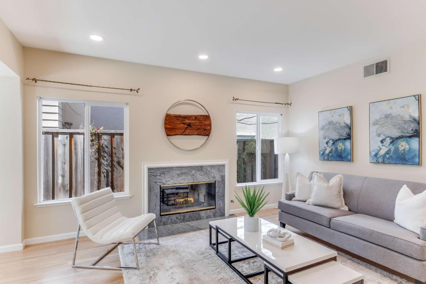 11627 Cedar Spring Court Cupertino, CA 95014 - Photo 16 of 54 a living room with furniture a clock and a fireplace