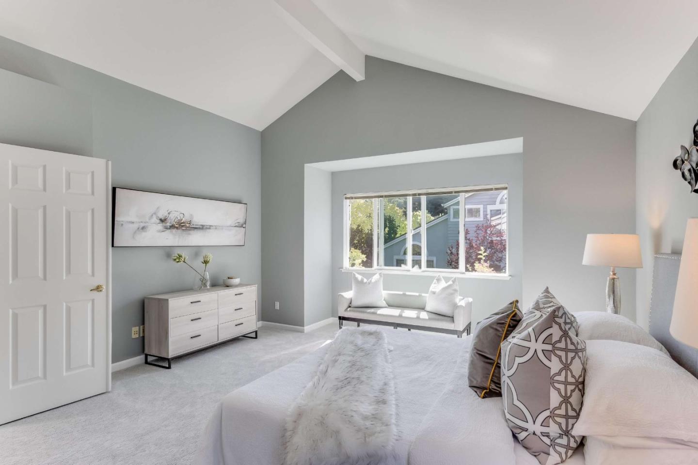 11627 Cedar Spring Court Cupertino, CA 95014 - Photo 18 of 54 a spacious bedroom with a bed and a large window