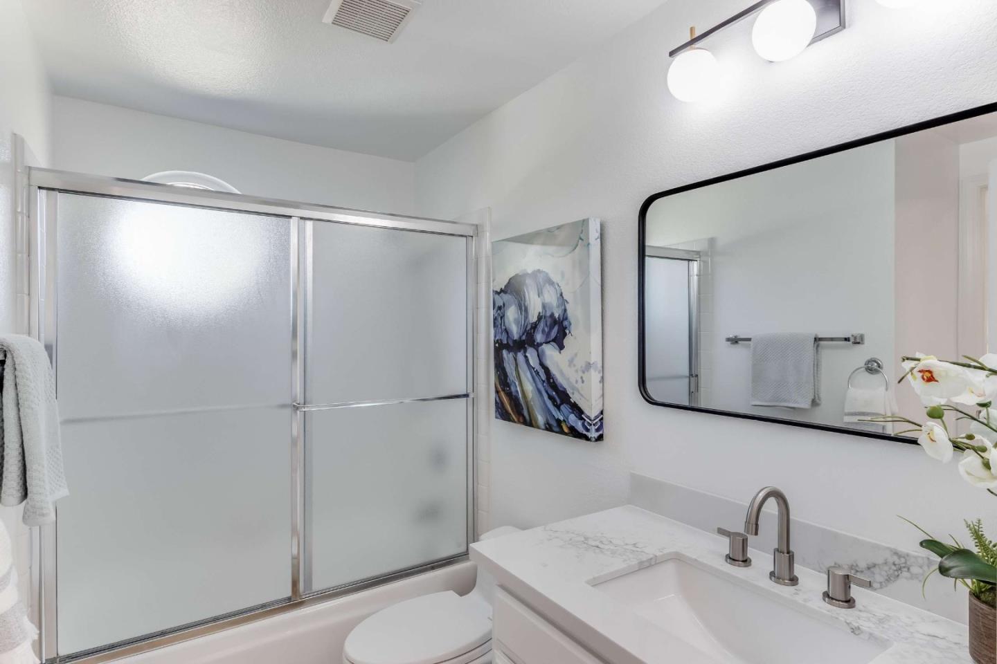 11627 Cedar Spring Court Cupertino, CA 95014 - Photo 25 of 54 a bathroom with a granite countertop sink mirror and shower