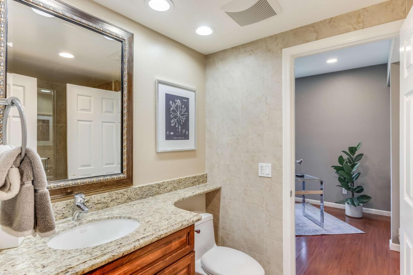 11627 Cedar Spring Court Cupertino, CA 95014 - Photo 30 of 54 a bathroom with a granite countertop sink toilet and shower