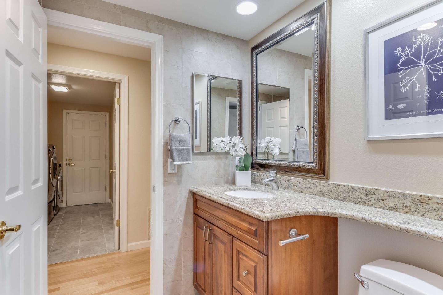11627 Cedar Spring Court Cupertino, CA 95014 - Photo 32 of 54 a bathroom with a granite countertop sink and a mirror