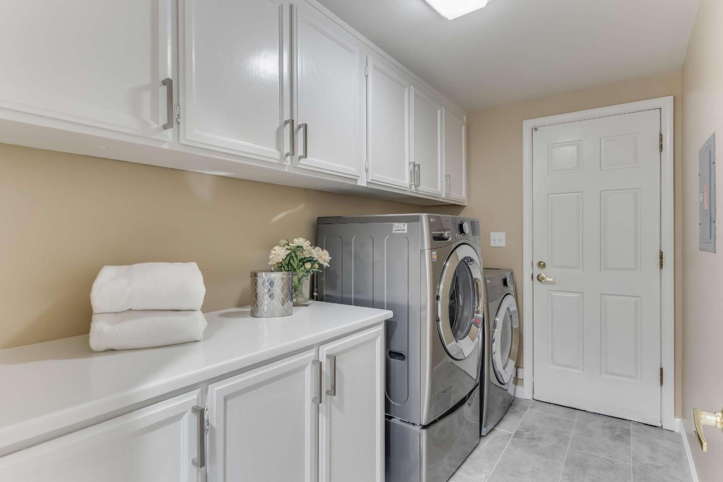 11627 Cedar Spring Court Cupertino, CA 95014 - Photo 36 of 54 a utility room with cabinets washer and dryer