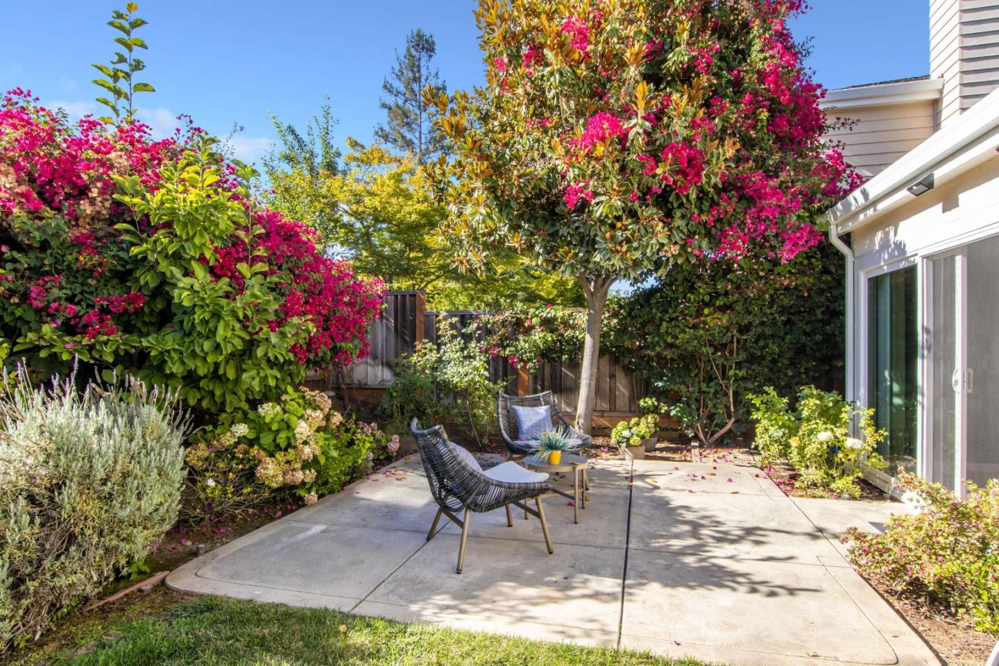 11627 Cedar Spring Court Cupertino, CA 95014 - Photo 40 of 54 a backyard of a house with table and chairs and potted plants