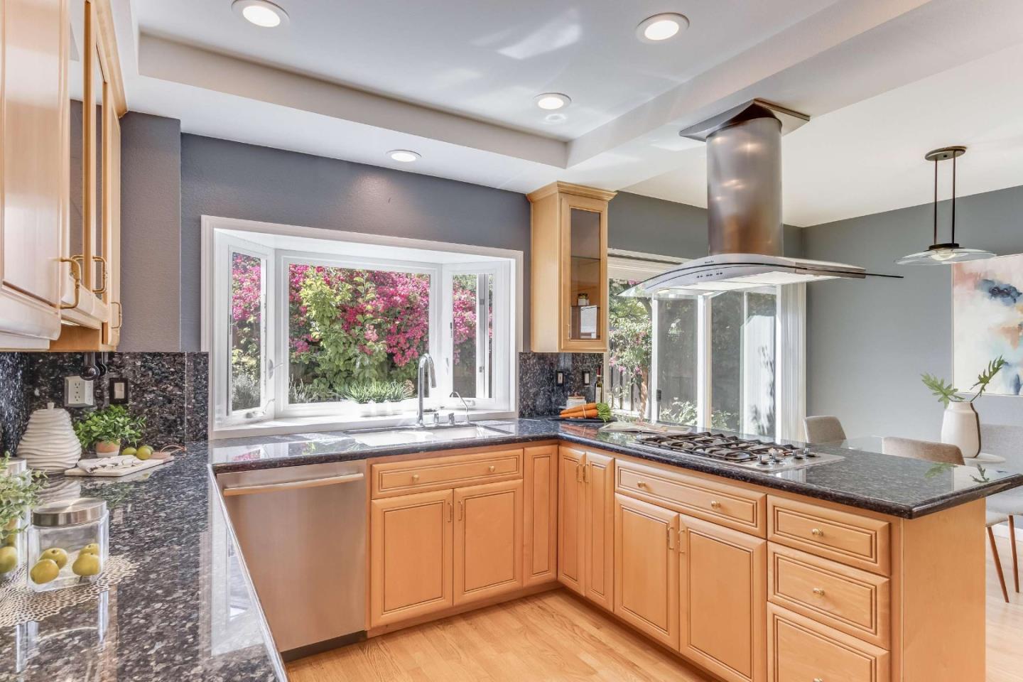 11627 Cedar Spring Court Cupertino, CA 95014 - Photo 8 of 54 a kitchen with stainless steel appliances granite countertop a sink and a large window
