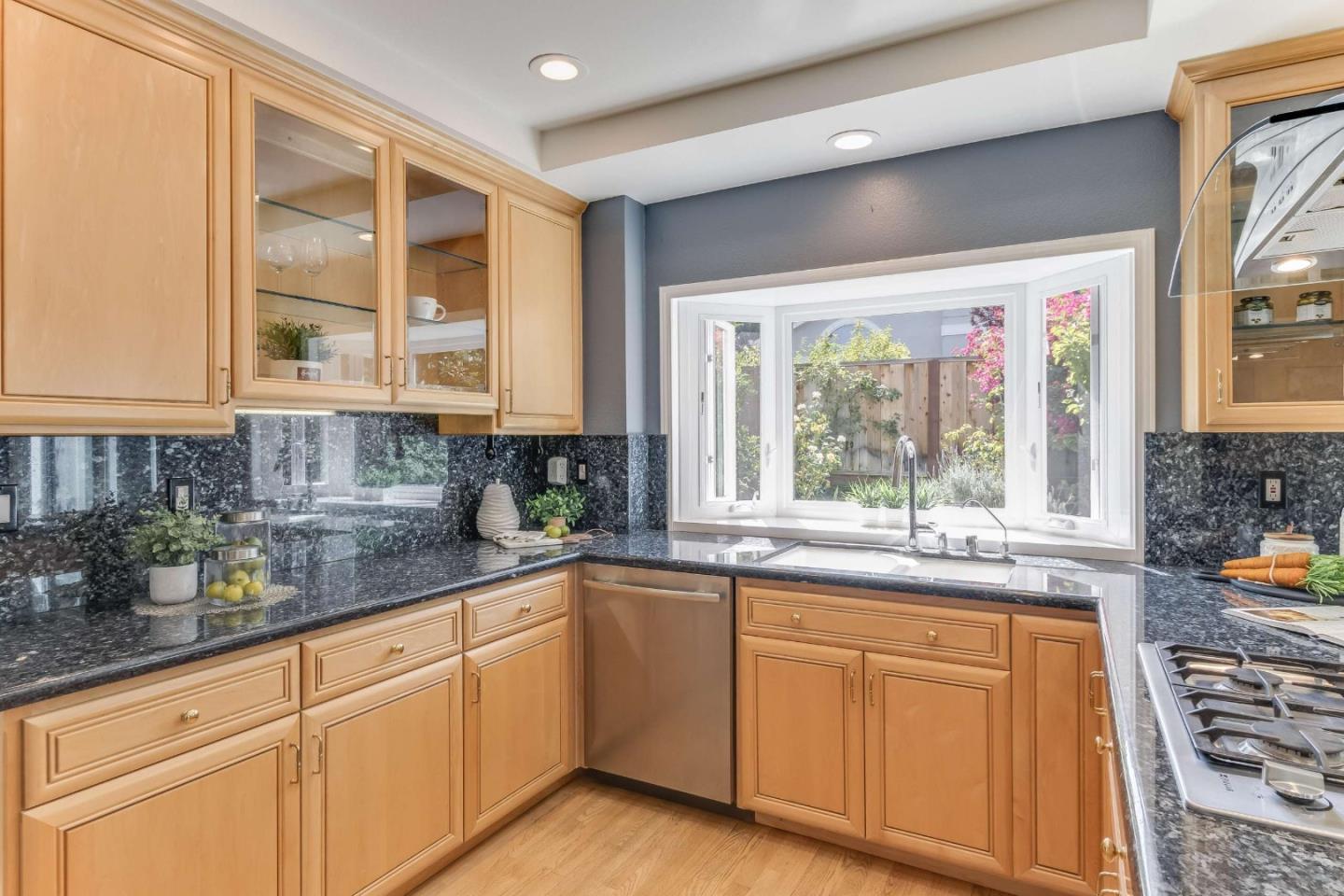 11627 Cedar Spring Court Cupertino, CA 95014 - Photo 9 of 54 a kitchen with stainless steel appliances granite countertop white cabinets and a window