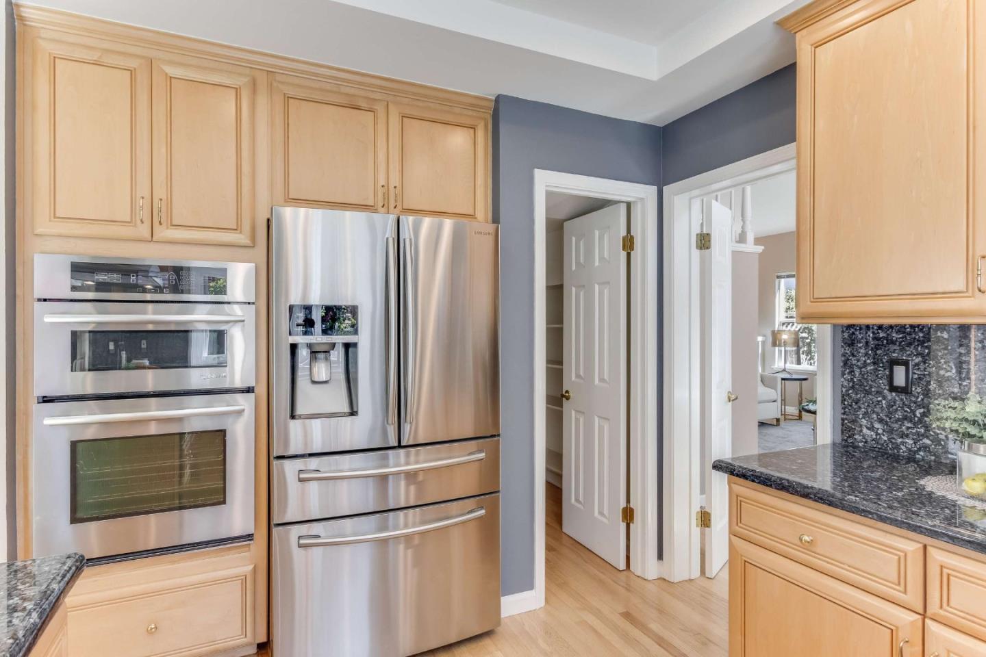 11627 Cedar Spring Court Cupertino, CA 95014 - Photo 10 of 54 a kitchen with stainless steel appliances granite countertop a refrigerator and a stove top oven