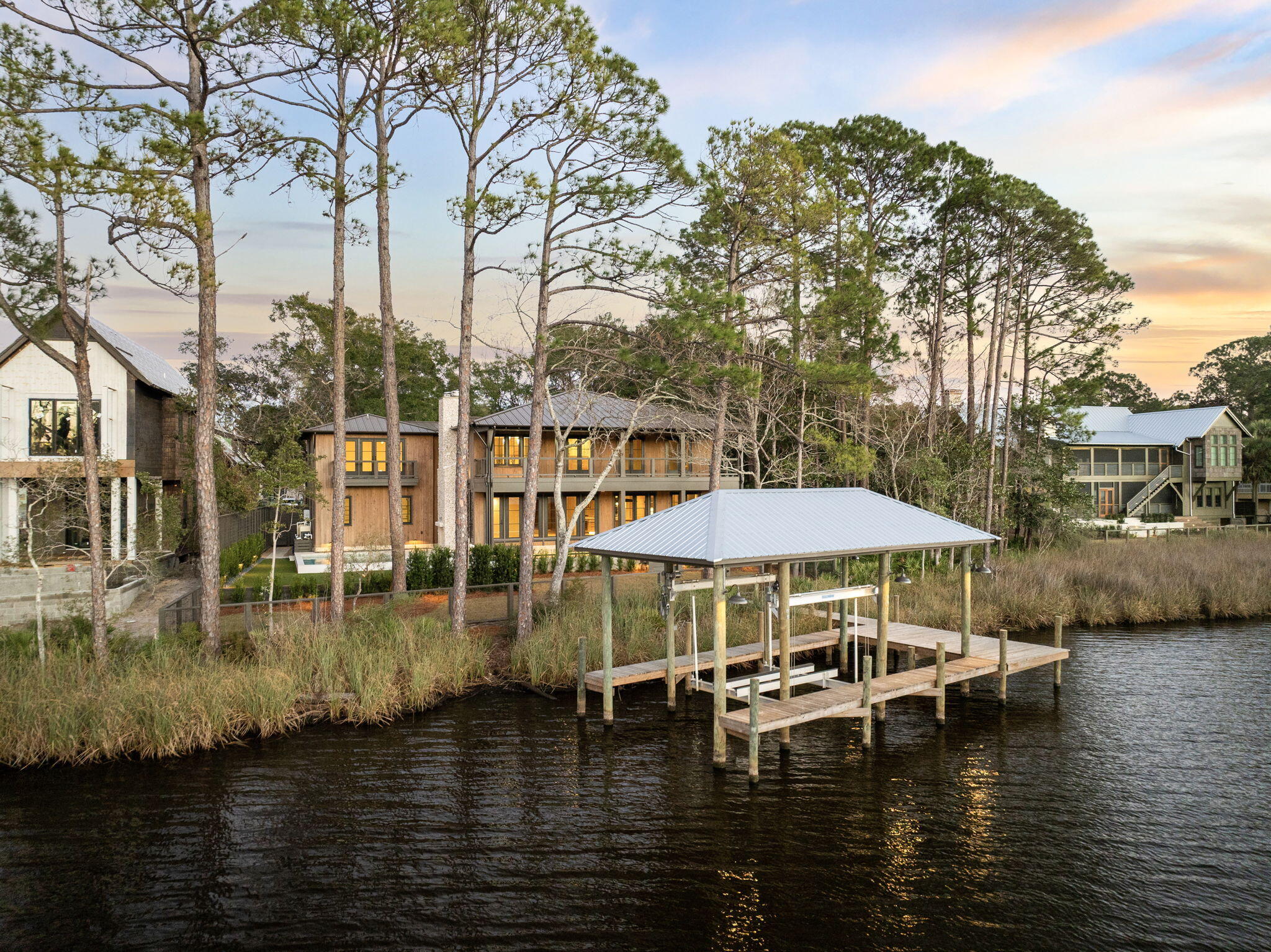 613 Eden Drive Point Washington, FL 32459 - Photo 2 of 81 a blue swimming pool with lawn chairs under an umbrella