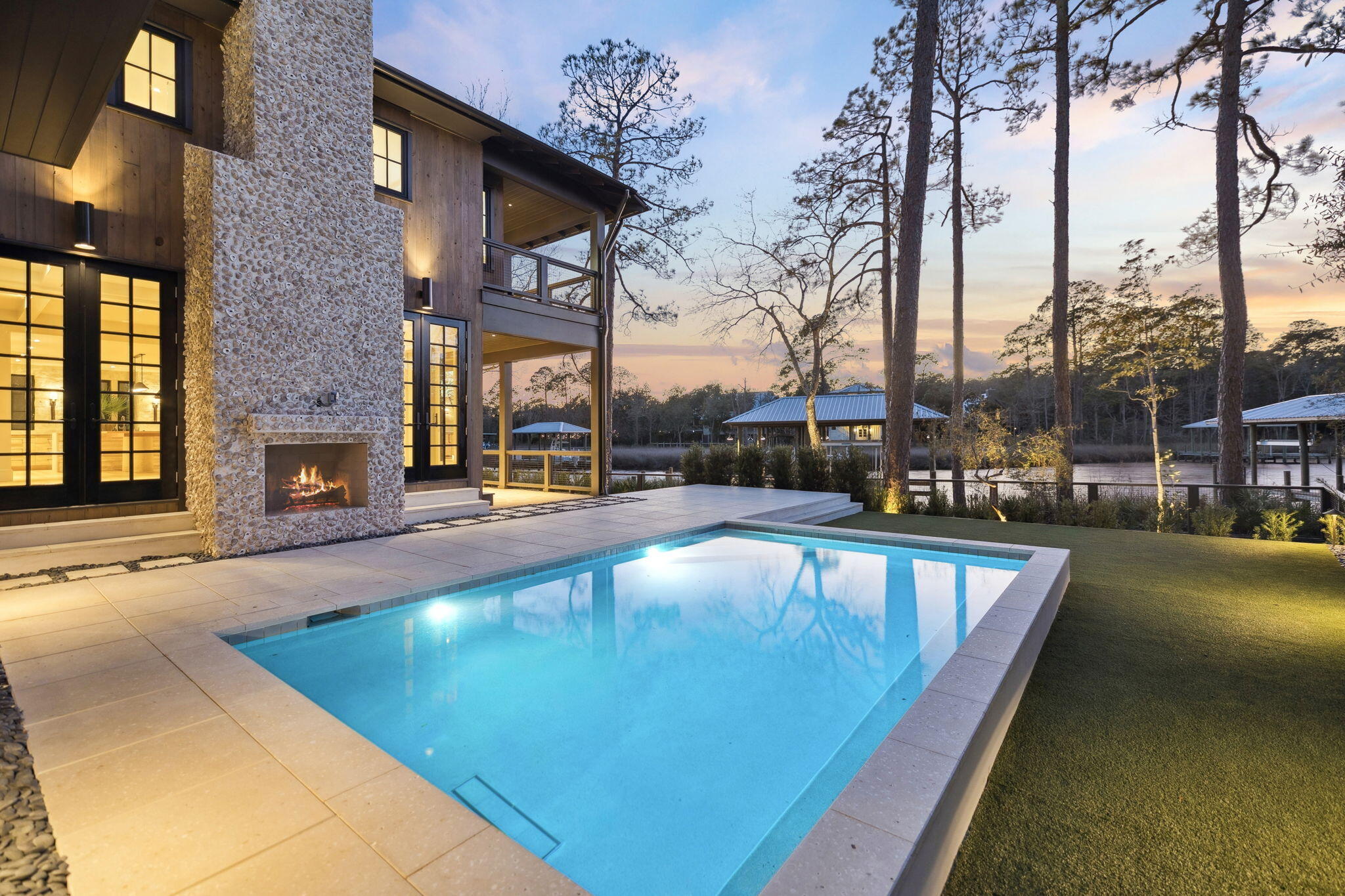 613 Eden Drive Point Washington, FL 32459 - Photo 52 of 81 a view of a swimming pool with a lawn chairs under an umbrella