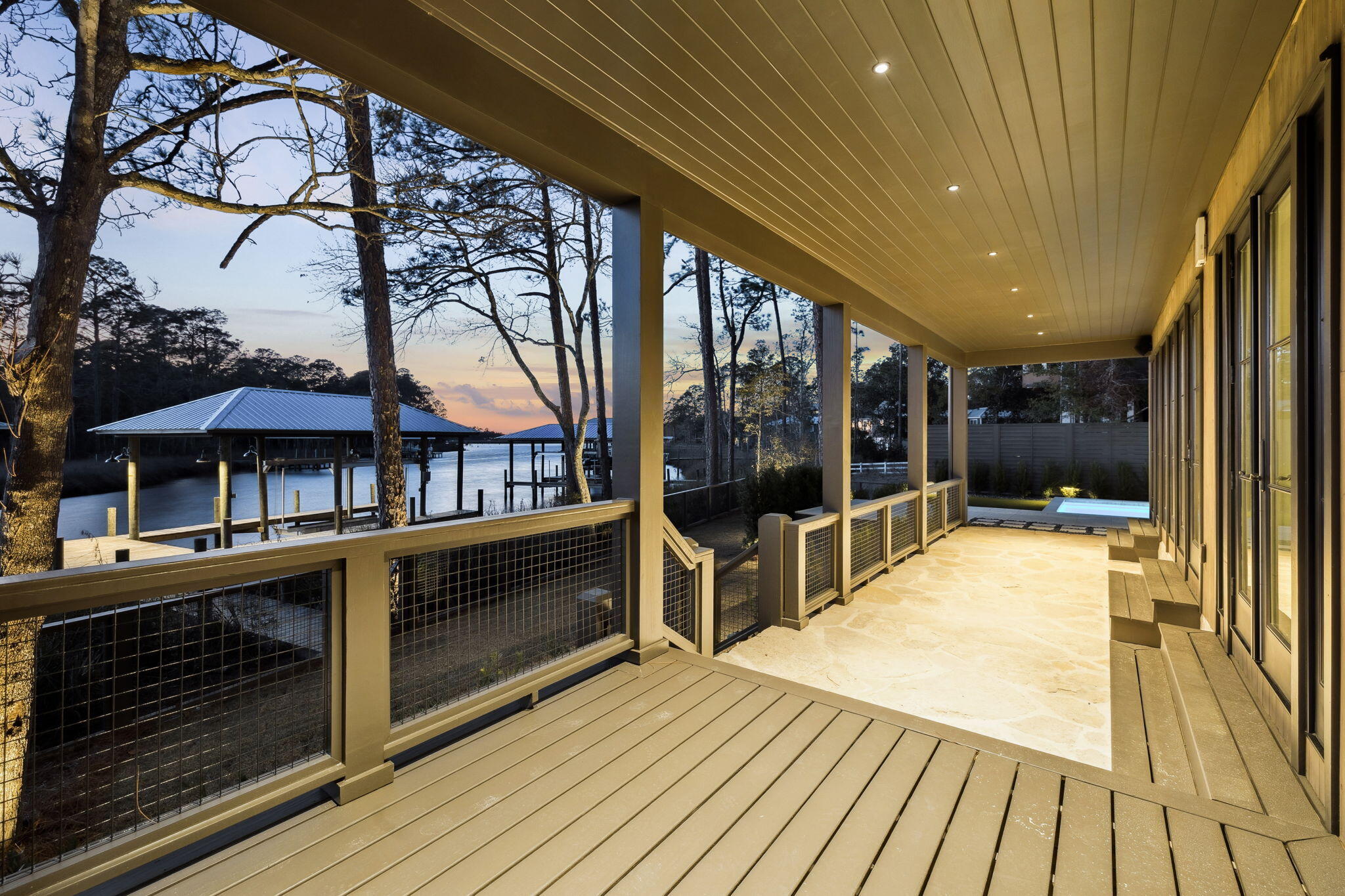 613 Eden Drive Point Washington, FL 32459 - Photo 55 of 81 a view of a patio with table and chairs under an umbrella with wooden floor