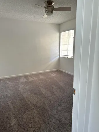 a view of an empty room and a window