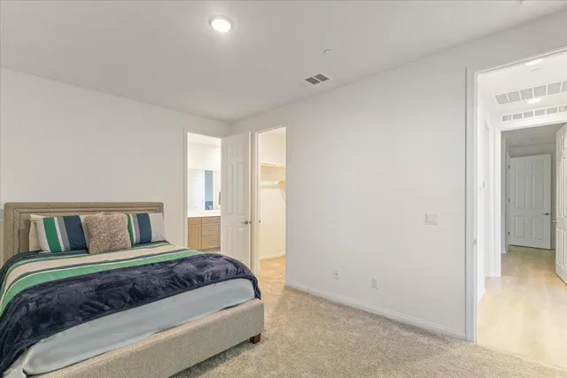 a bedroom with a large bed and a closet