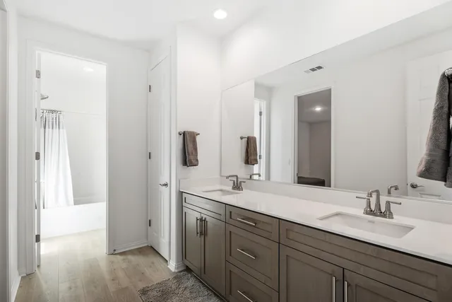 a bathroom with a double vanity sink mirror and double
