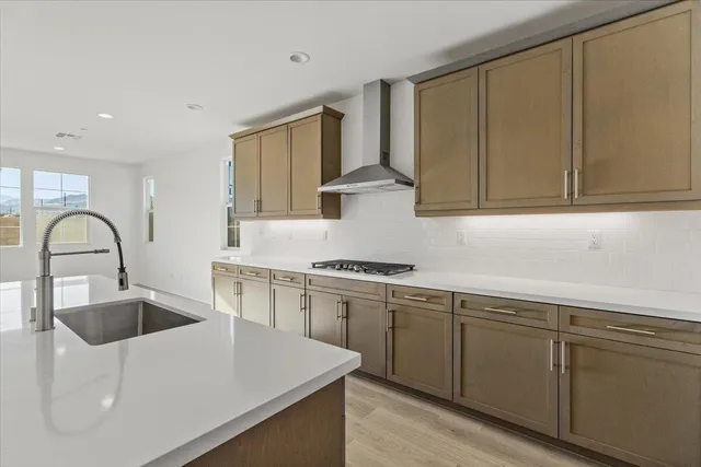 a kitchen with stainless steel appliances granite countertop a sink stove and cabinets