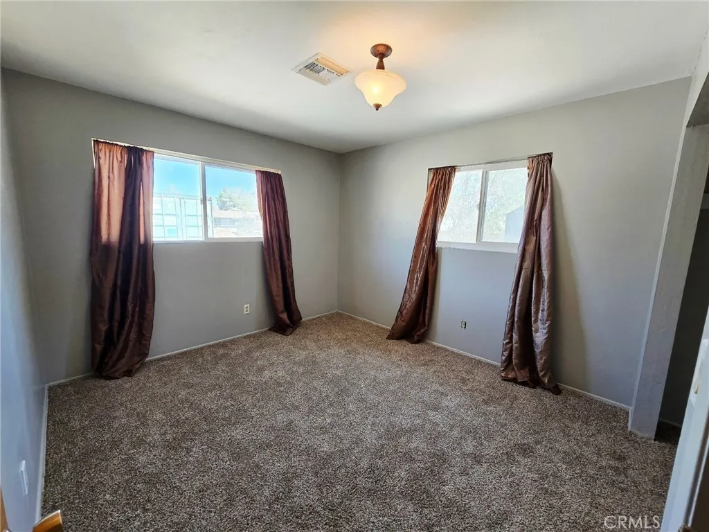 20221 Modoc Road Apple Valley, CA 92308 - Photo 13 of 23 an empty room with windows and closet