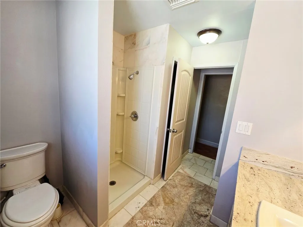 20221 Modoc Road Apple Valley, CA 92308 - Photo 15 of 23 a bathroom with a granite countertop shower and a toilet