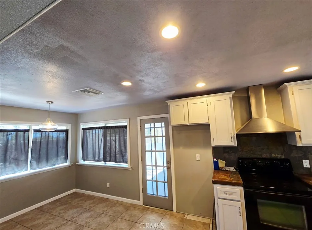 20221 Modoc Road Apple Valley, CA 92308 - Photo 7 of 23 a kitchen with granite countertop a stove a sink and a refrigerator