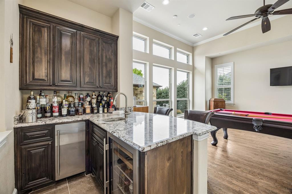 1005 Berkshire Road Southlake, TX 76092 - Photo 22 of 40 a living room with stainless steel appliances granite countertop a sink and dishwasher with wooden floor