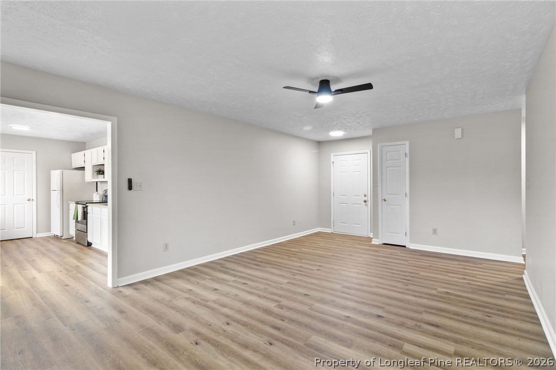 388 Woodwind Drive Spring Lake, NC 28390 - Photo 14 of 31 a view of an empty room with wooden floor