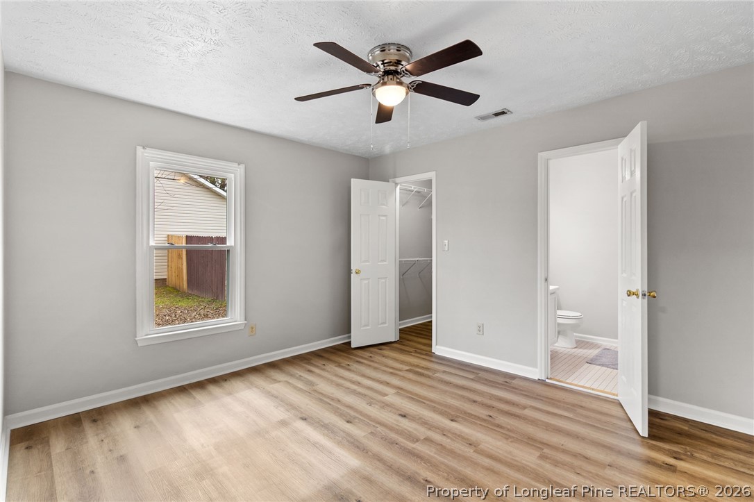 388 Woodwind Drive Spring Lake, NC 28390 - Photo 15 of 31 wooden floor in an empty room with a window