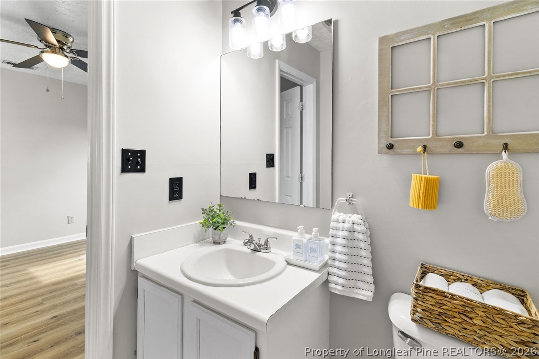 388 Woodwind Drive Spring Lake, NC 28390 - Photo 17 of 31 a bathroom with a sink and a mirror