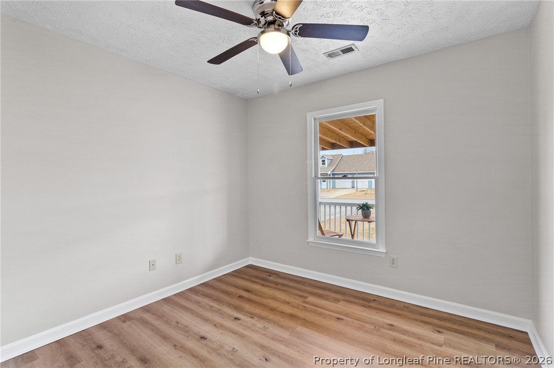 388 Woodwind Drive Spring Lake, NC 28390 - Photo 20 of 31 an empty room with a window and a ceiling fan