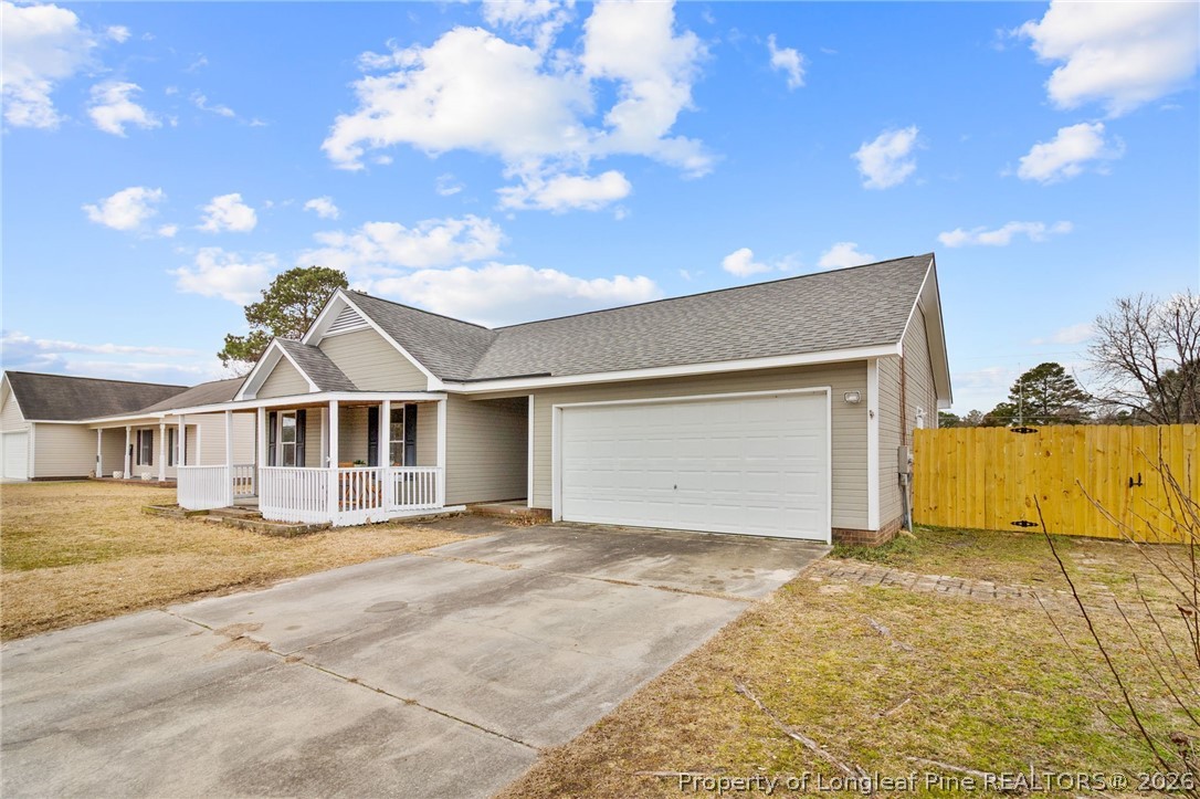 388 Woodwind Drive Spring Lake, NC 28390 - Photo 2 of 31 a front view of a house with a yard