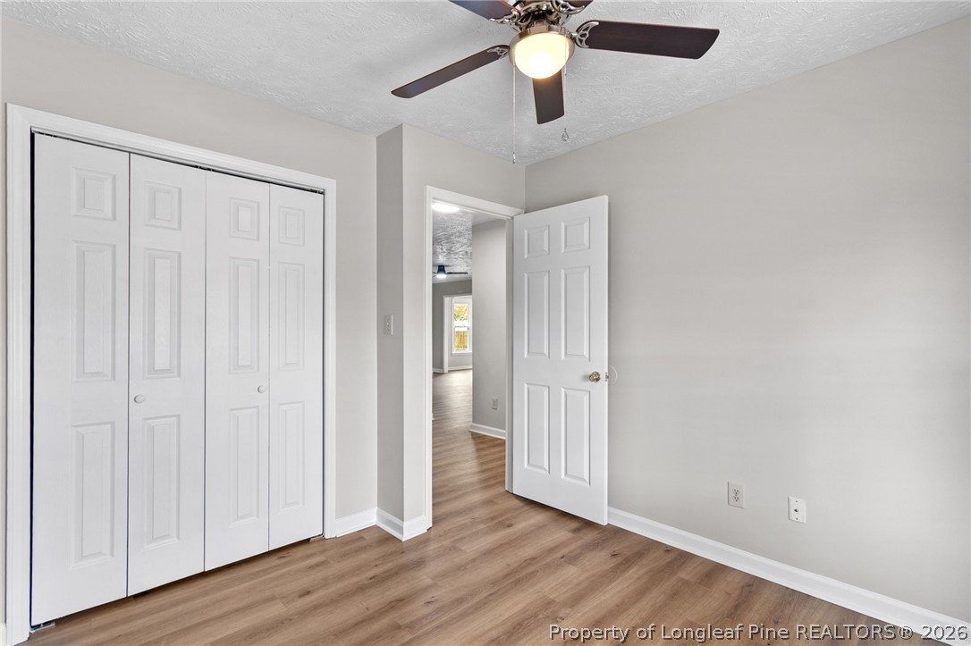 388 Woodwind Drive Spring Lake, NC 28390 - Photo 21 of 31 an empty room with wooden floor fan and windows