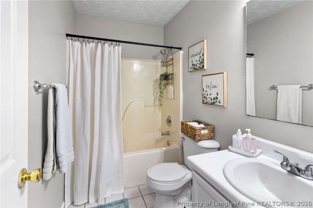 388 Woodwind Drive Spring Lake, NC 28390 - Photo 22 of 31 a bathroom with a sink toilet and shower