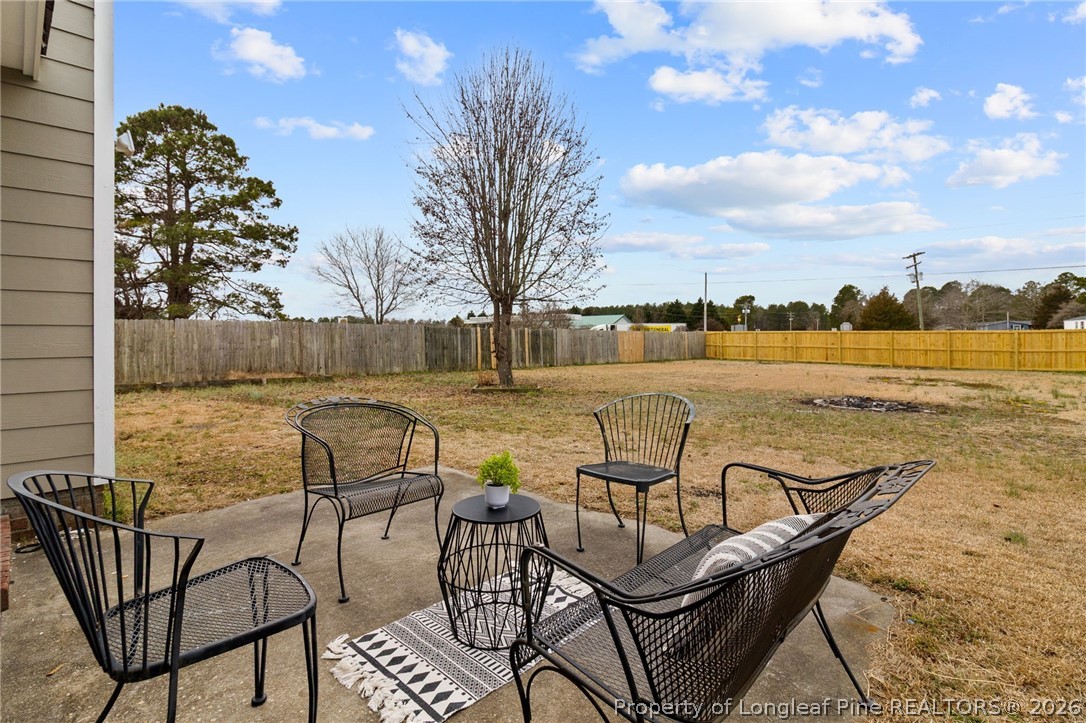388 Woodwind Drive Spring Lake, NC 28390 - Photo 25 of 31 a view of a lake with table and chairs