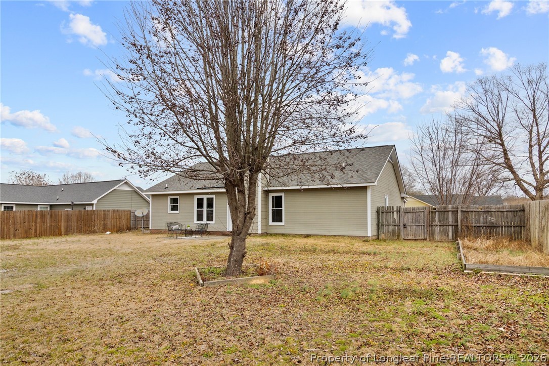 388 Woodwind Drive Spring Lake, NC 28390 - Photo 28 of 31 a front view of a house with a yard and garage