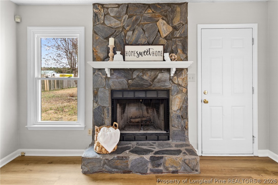 388 Woodwind Drive Spring Lake, NC 28390 - Photo 7 of 31 a living room with a fireplace and a window