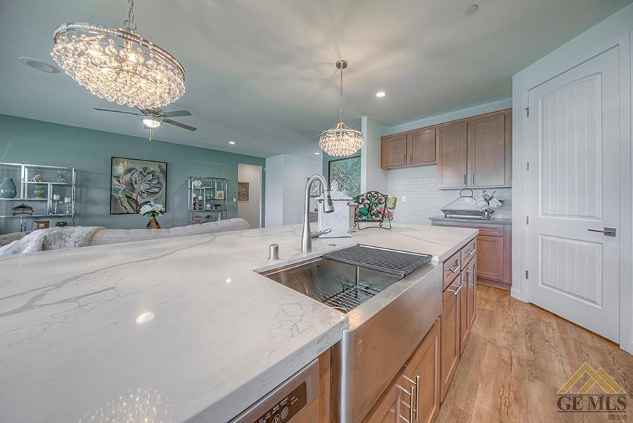 Undisclosed Address Bakersfield, CA 93311 - Photo 4 of 9 a kitchen with a sink and a stove top oven with wooden floor