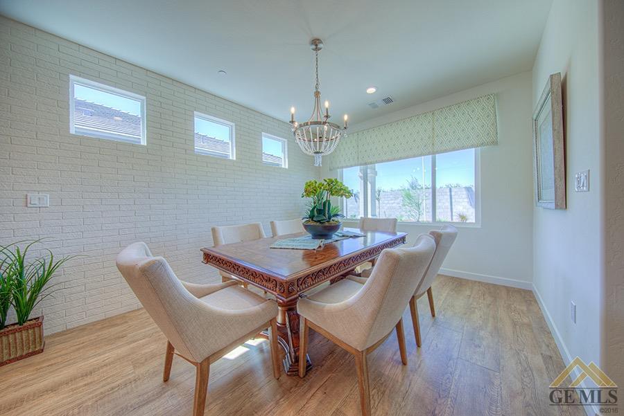 Undisclosed Address Bakersfield, CA 93311 - Photo 5 of 9 a dining room with furniture potted plants and wooden floor