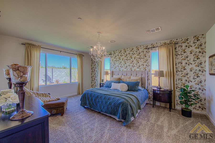 Undisclosed Address Bakersfield, CA 93311 - Photo 6 of 9 a bedroom with a bed and a chandelier
