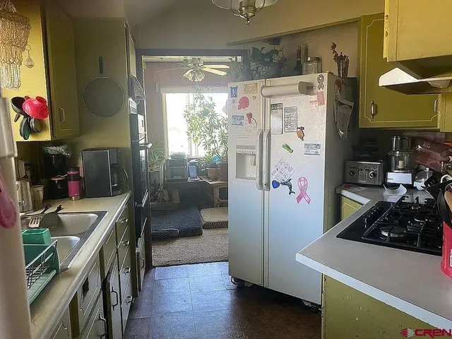 a kitchen with stainless steel appliances granite countertop a refrigerator and a stove