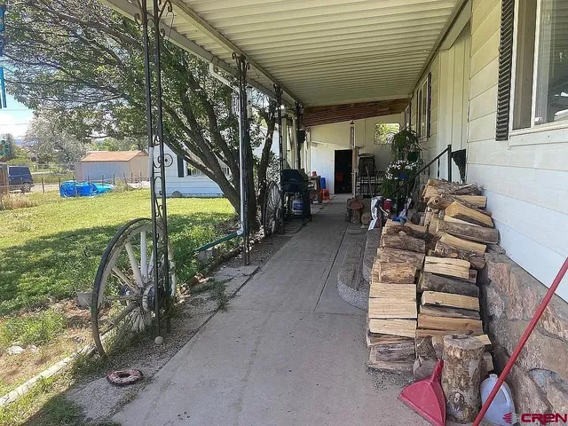 a view of a porch with furniture and a small yard