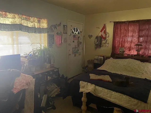a bedroom with a bed and a table