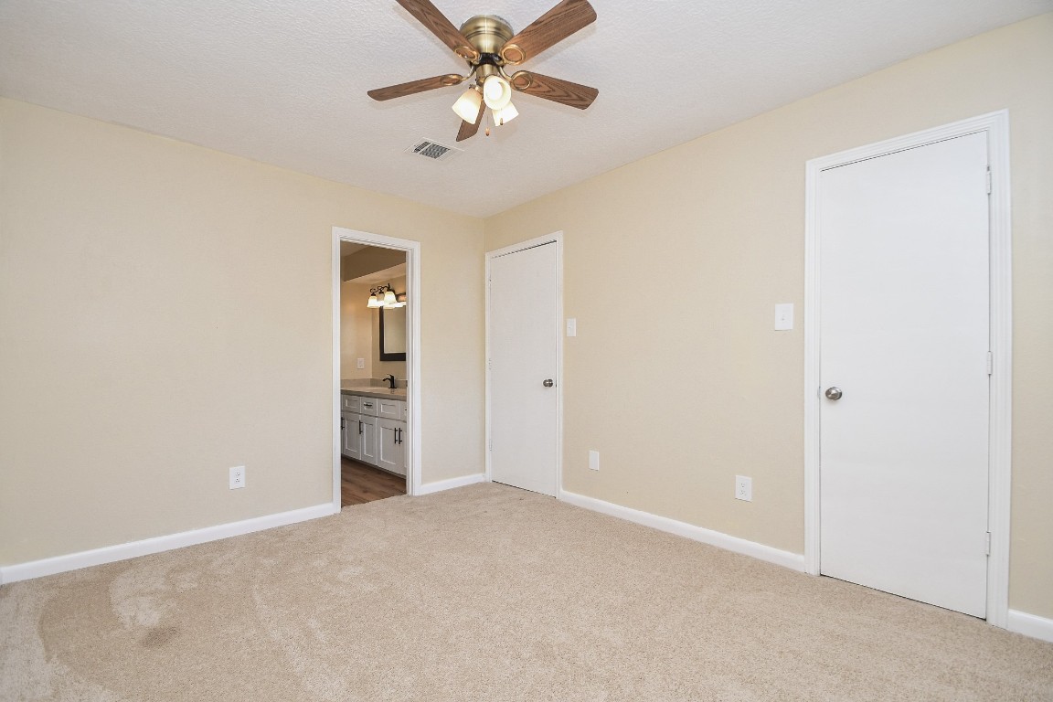 4730 Theall Road Houston, TX 77066 - Photo 18 of 32 an empty room with closet and windows