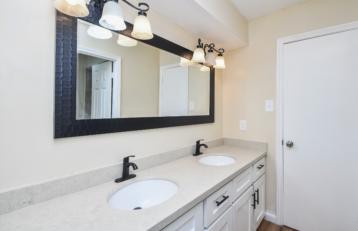 4730 Theall Road Houston, TX 77066 - Photo 19 of 32 a bathroom with a sink and a mirror