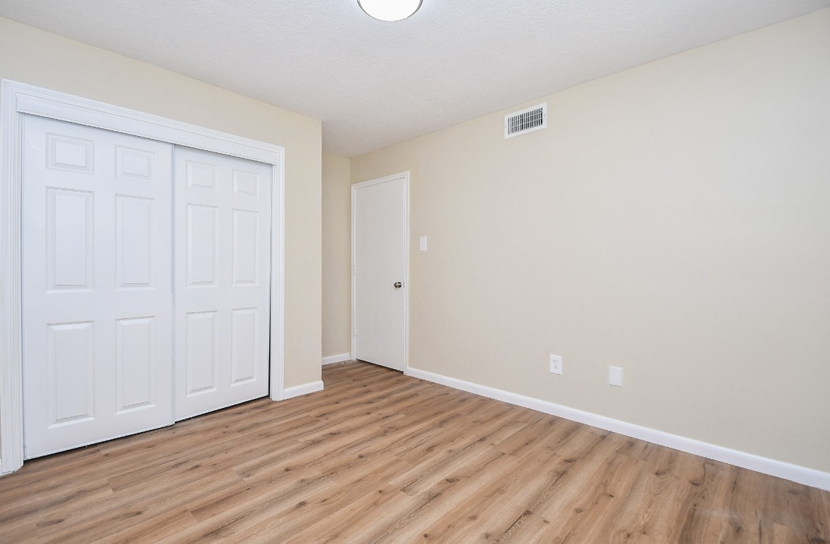4730 Theall Road Houston, TX 77066 - Photo 22 of 32 a view of an empty room with wooden floor