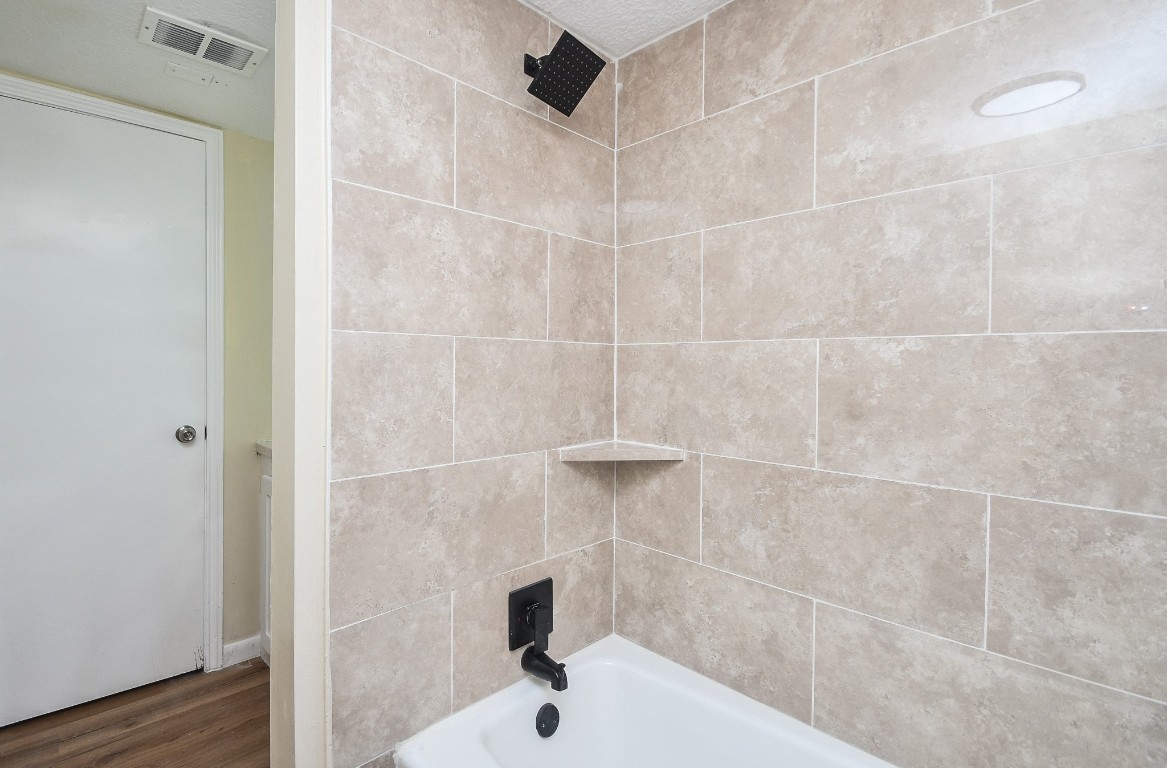 4730 Theall Road Houston, TX 77066 - Photo 25 of 32 a bathroom with a sink and a shower