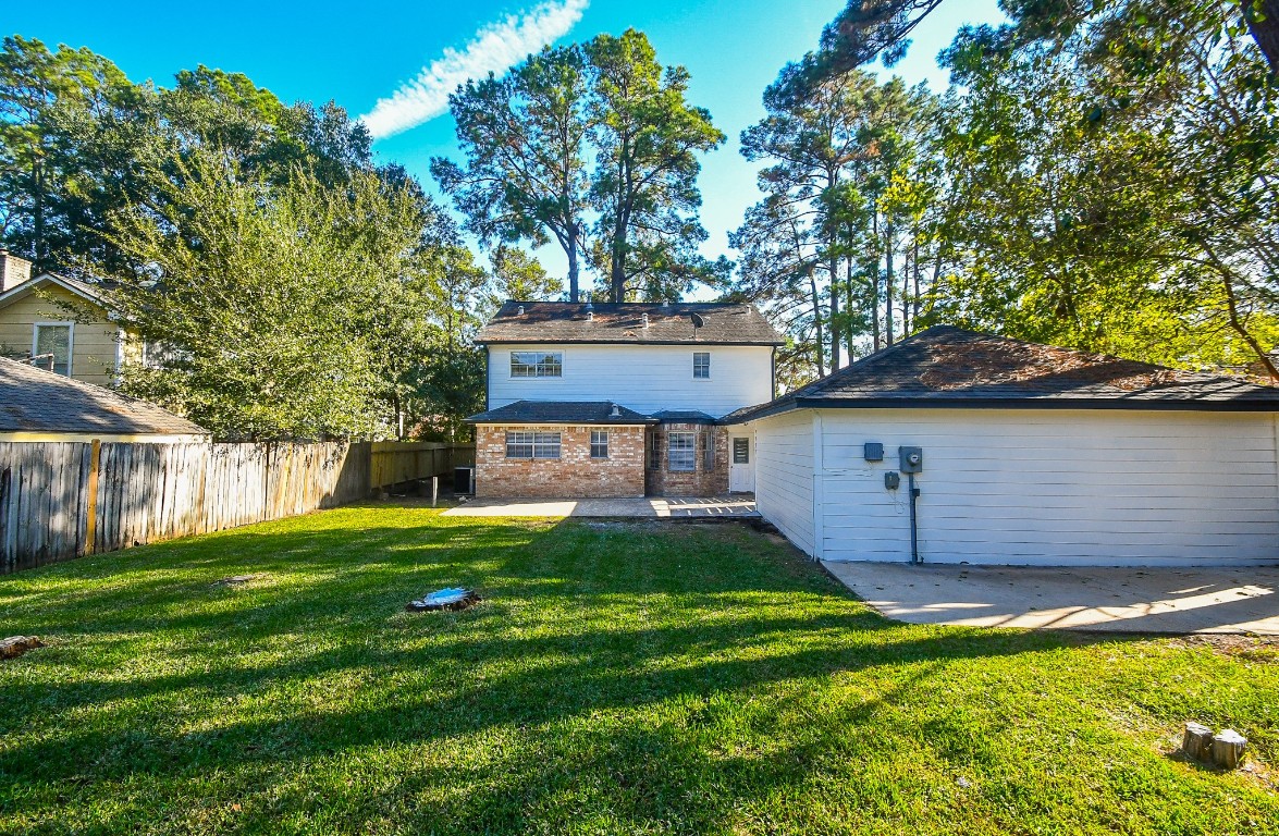 4730 Theall Road Houston, TX 77066 - Photo 30 of 32 a front view of a house with a yard and a large tree