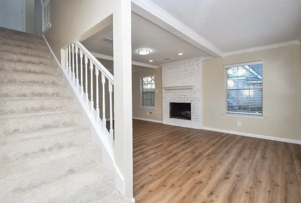a view of an entryway with wooden floor and livingroom view