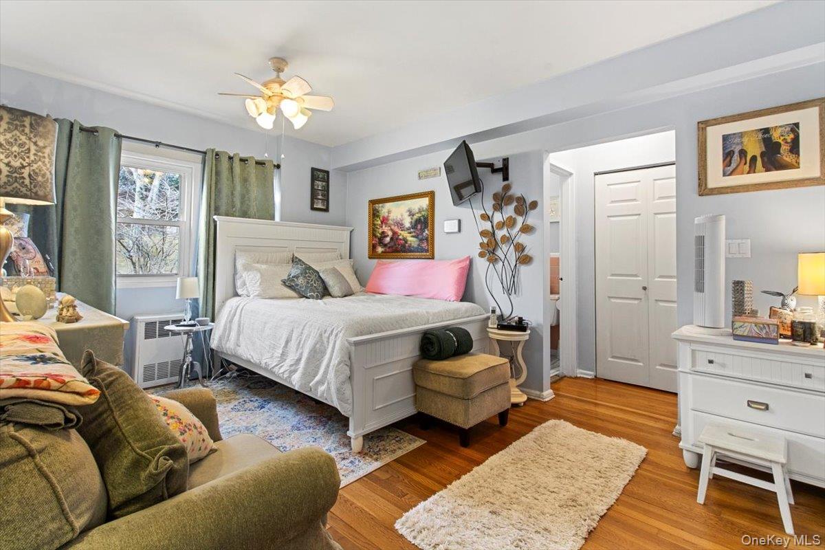 103 Wiltshire Road, Unit D11 Scarsdale, NY 10583 - Photo 11 of 23 a bedroom with a bed and wooden floor